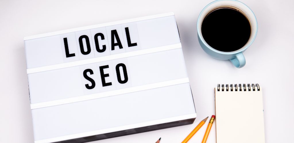 Lightbox displaying 'LOCAL SEO' with coffee cup and writing materials on white background